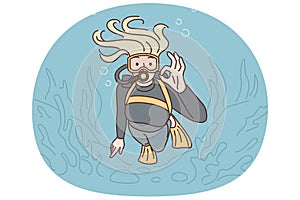 Woman diver swims underwater in scuba gear and goggles showing OK gesture exploring underwater world