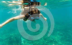 Woman diving or snorkelling in ocean