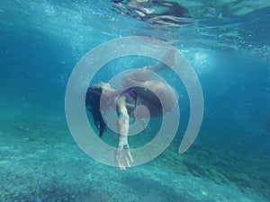 Woman diving underwater