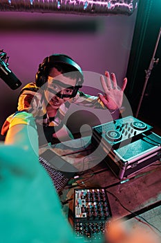 Woman dj artist mixing sounds on turntables