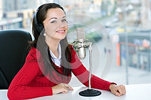 A woman DJ is in front of a mic