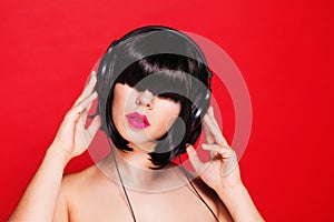 Woman dj listening to music on headphones enjoying