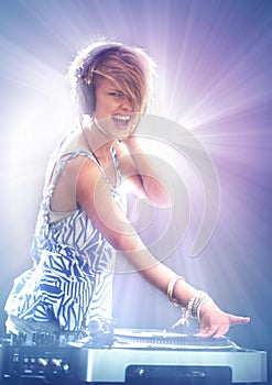 Woman, dj and portrait with headphones for music on stage with lens flare, mixing and gig at rave party for