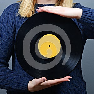Woman dj portrait with vinyl record against gray background
