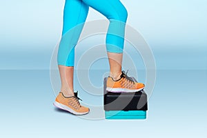 Woman do exercise on an aerobic and fitness step