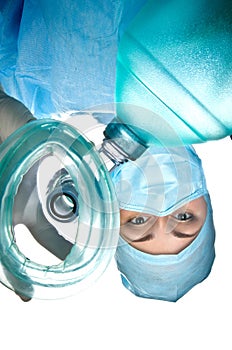 Woman doctor anesthetist holding an oxygen mask with a balloon.