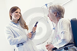 Woman doctor consulting with a senior patient