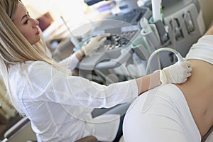 Woman doctor doing kidney ultrasound examination in clinic