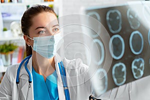 Woman doctor examines head mri scan in hospital