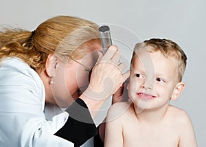 Woman doctor examining child's ear