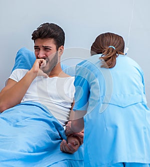 Woman doctor examining male patient in hospital