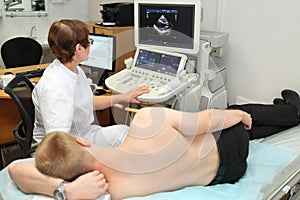 Woman doctor examining patient with abdomen photo