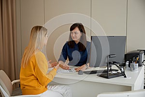 Woman doctor explaining x-ray scan to patient during medical appointment