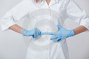 Woman doctor hands in medical latex blue gloves