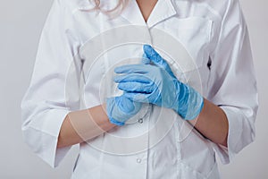 Woman doctor hands in medical latex blue gloves