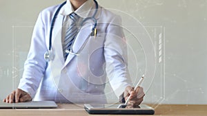 Woman doctor holding digital pencil and touching screen on smart device