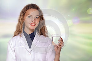 Woman doctor holding a glass of clean water and smiling