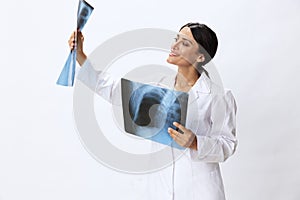 Woman doctor holding X-ray in robe on white background, consequences of covid-19, pneumonia and lung damage, concept of