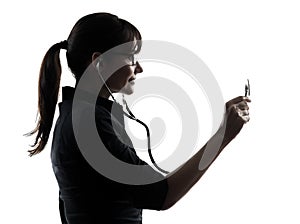 Woman doctor holding stethoscope silhouette