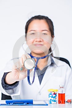 Woman doctor holding stethoscope to examine the patient.