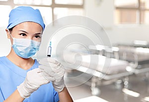 Woman doctor holding syringe needle