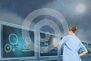 Woman doctor interacting with medical interfaces against blue background with flares