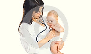 Woman doctor listens to the heart of child isolated on white