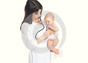 Woman doctor listens to heart of a child on white background