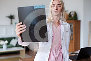 Woman doctor looking at an X-ray image