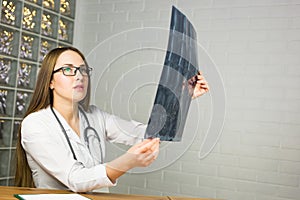 Woman Doctor Looking at X-Ray Radiography in doctor`s office