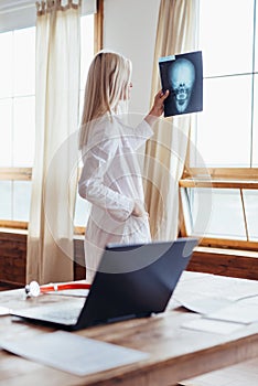 Woman Doctor Looking at X-Ray Radiography in hospital