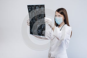 Woman Doctor looking at X-Ray radiography isolated on white background.