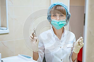 Woman doctor in mask with tools in hand