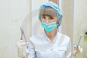 Woman doctor in mask with tools in hand