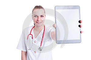 Woman doctor or medic showing blank screen wireless tablet