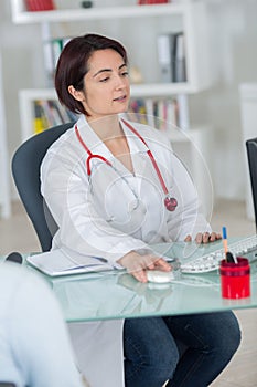 Woman doctor in modern office sitting at desk