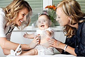 Woman Doctor with Mother and Baby