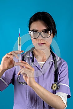 woman doctor or nurse in white med uniform and gloves with syringe in hands on isolated