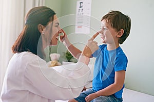 Woman doctor, playing and child fun at a hospital for healthcare and medical consultation. Smile, trust and pediatrician