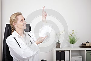 Woman Doctor Pointing and Looking to Upper Right