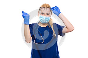 Woman doctor in scrubs and gloves with face mask