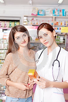 Woman doctor showing antibiotic to buyer