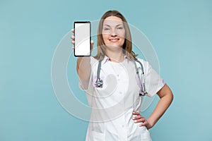 Woman doctor with a smartphone, on a blue background. Place for advertising. Copy paste. healthcare concept.