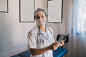 Woman doctor smiling with tablet and stethoscope