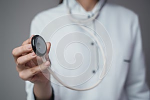 Woman doctor with stethescope dressed in white labcoat