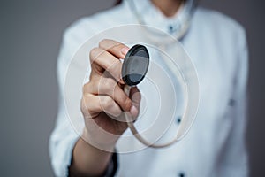 Woman doctor with stethescope dressed in white labcoat