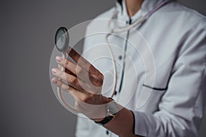 Woman doctor with stethescope dressed in white labcoat photo