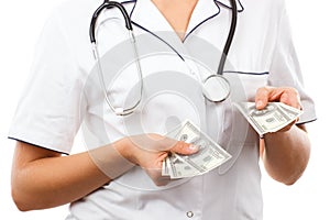 Woman doctor with stethoscope and currencies dollar, corruption or bribe concept