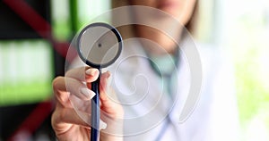 Woman a doctor with a stethoscope in her hands, shallow focus