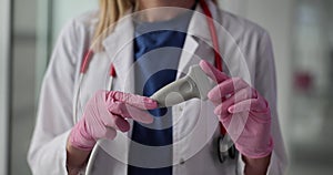 Woman doctor with stethoscope holds transducer in clinic